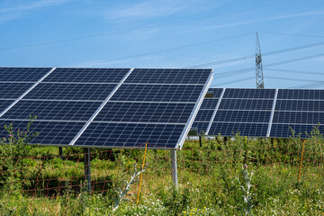 Solar power panels with power lines in the back seen in Germany