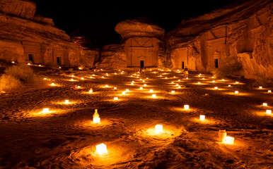 Tombs at the Mada'in Saleh (Hegra) archeological site lit up after dark, north west Saudi Arabia