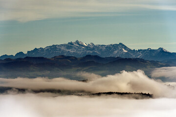 Aerial view from local mountain Uetliberg on a foggy winter day with Alpstein and Säntis peak and sea of fog at Christmas Day. Photo taken December 25th, 2022, Uetliberg, Canton Zürich, Switzerland. - Powered by Adobe