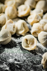 Raw dumplings on the table with flour.