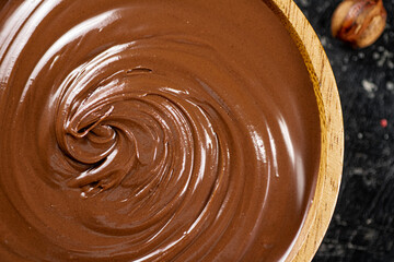 Hazelnut butter in a wooden plate. 