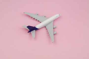 Airplane on pink background with copy space for text. Travel and transportation concept.	