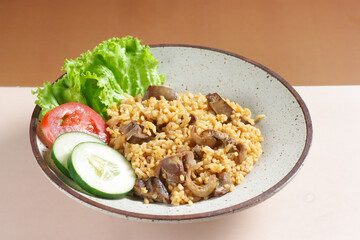 Nasi Goreng hati ampela is Fried Rice with  chicken gizzard heart garnished with fresh cucumber and tomatoes slices.