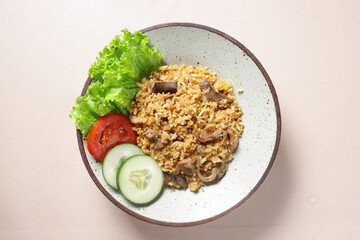 Nasi Goreng hati ampela is Fried Rice with  chicken gizzard heart garnished with fresh cucumber and tomatoes slices.