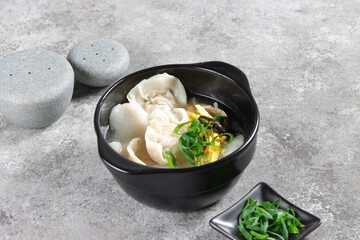 Tteok Mandu Guk is korean Rice Cake Soup with Dumplings in Beef Broth.