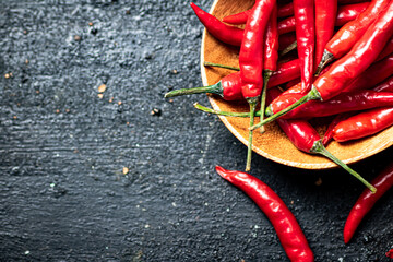 Chili peppers on a wooden plate. 