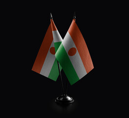 Small national flags of the Niger on a black background