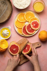 Naklejka na ściany i meble Cutting orange slices, cooking process top view