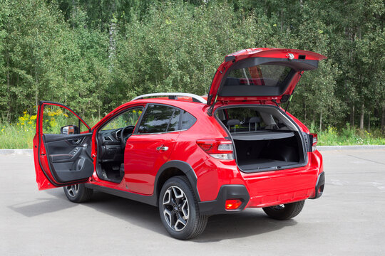 Russia, Izhevsk - August 13, 2020: New modern Subaru XV car with open car boot and open door driver. Back and sive view.
