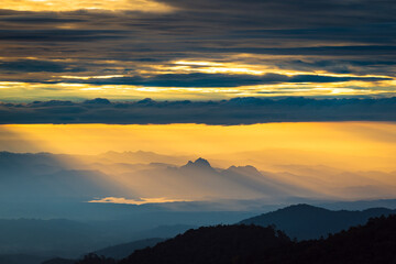 Fototapeta na wymiar Sunlight hitting the mountain peak with dramatic sky in the northern of thailand