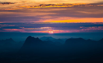sun rises behind mountains with perfect sky in the northern of thailand
