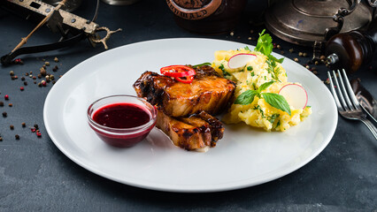 Dinner fried pork ribs with caramelized onions, mashed potatoes, chili peppers, herbs and lingonberry sauce.