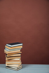 a stack of old instructional books on a brown background