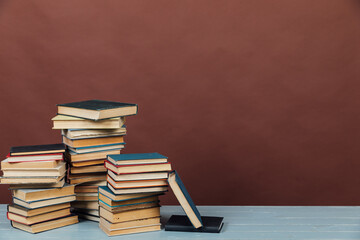 a stack of old instructional books on a brown background