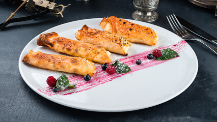 Fried sweet thin pancakes with cottage cheese, fresh raspberries, blueberries and mint.
