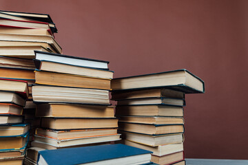 a stack of old instructional books on a brown background