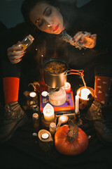 Close up woman witch brewing herbs and adding spices portrait picture. Witchcraft. Closeup top view...