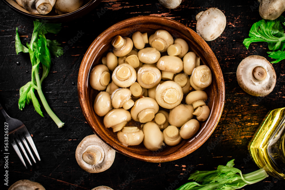 Canvas Prints Homemade pickled mushrooms in a wooden bowl. 