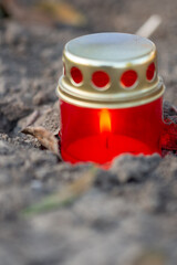 a red candle in a Romanian cemetery