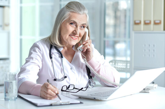 senior female doctor talking on the phone