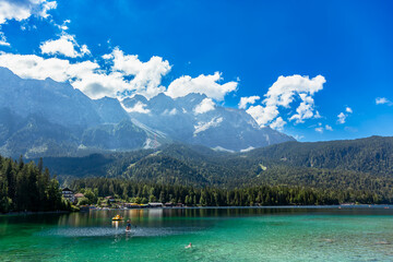 Lake in the mountains in summer. Beautiful Landscape scenery. Bavarian panorama of the beach of lake Eibsee, Bavaria Germany. Mountain range of the Wettersteingebirge in Background. 