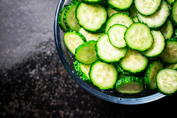 Full glass bowl of chopped fresh cucumbers. 