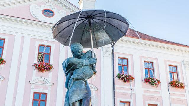 Tartu, Estonia - September 27, 2018: Sculpture of kissing studens under an umbrella in front of the town hall of Tartu in Estonia