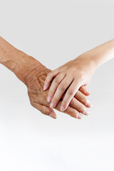 白背景の前で老人の手を握る子供の小さな手、敬老、介護、相続、福祉のイメージ