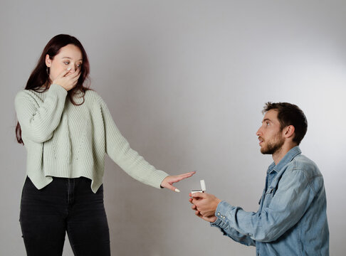 Rejection Of A Marriage Proposal When A Man Asks A Woman To Marry Him. White Background, Free And Isolated