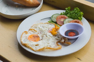 Breakfast with fried eggs and fresh vegetables