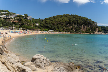 View of wide sand beach on sunny summer day. Beach Santa Cristina, Spain