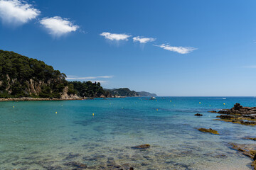 Naklejka premium View of a european sea beach with sunny summer sky. Romantic summer vacation