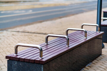 Bench with metal railings that do not allow homeless people to sleep on it