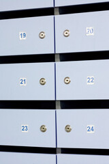 Blue mailbox doors with numbers closeup, background