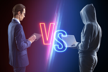 Hacker with laptop versus businessman with tablet on blurry dark neon background. Competition,...