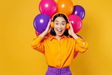 Happy fun surprised shocked excited young woman wearing casual clothes headphones celebrating near...