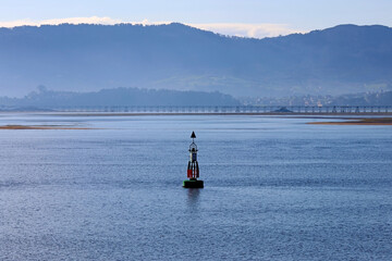 A sea buoy in the middle of a bay of water