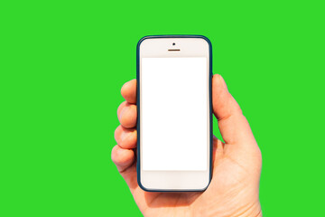 Hand holding mobile phone with empty white screen on the green background.Mockup balnk screen.