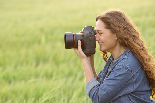 Woman taking photos in a field