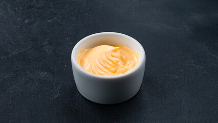 Mayonnaise sauce in a small ceramic bowl.
