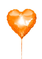 an inflatable ball in the shape of a heart in orange color isolated on a white background. Decoration for holiday, birthday. High quality photo