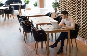 businessman working with laptop on restaurant