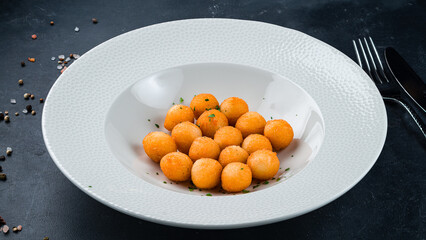 Snack breaded mozzarella cheese balls in a bowl.