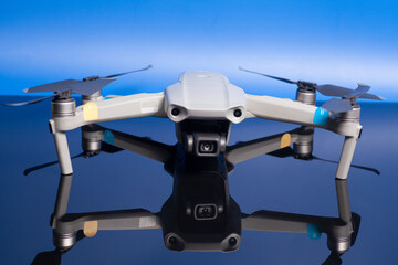 quadcopter drone aerial camera on blue background.