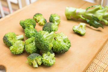 resh appetizing broccoli inflorescences on wooden board