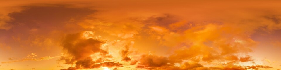 Obraz premium Golden glowing red orange overcast sunset sky panorama. Hdr seamless spherical equirectangular 360 panorama. Sky dome or zenith for 3D visualization and sky replacement for aerial drone 360 panoramas.