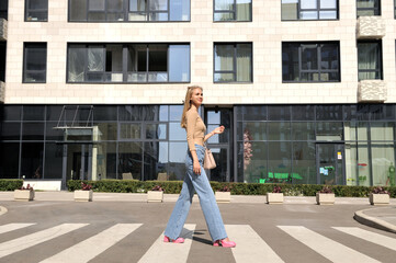 A beautiful girl crosses a pedestrian crossing.