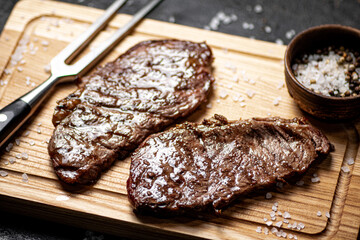 Fresh grilled steak on a spice cutting board. 