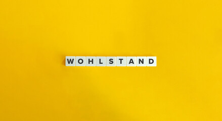Wohlstand (Prosperity in German Language) Word and Banner. Letter Tiles on Yellow Background. Minimal Aesthetics.
