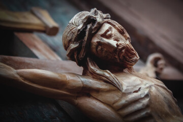 Jesus Christ crucified. Close up an ancient wooden statue. Horizontal image